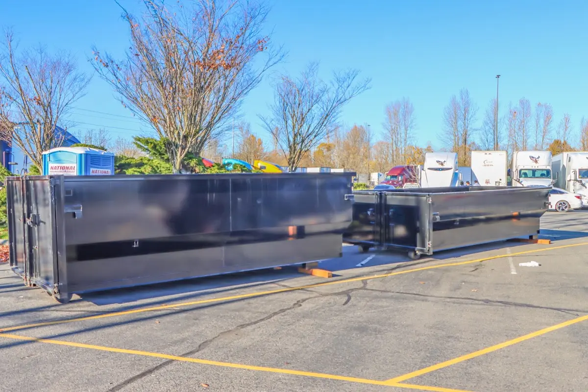 Professional dumpster rental service with roll-off container on residential driveway in Inverness